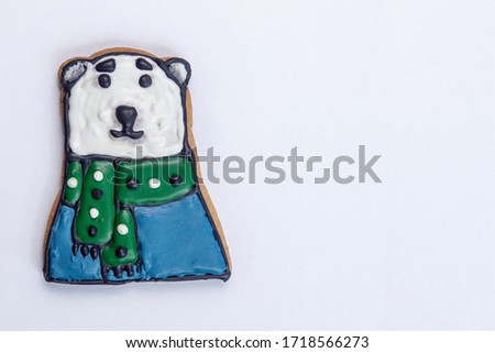 gingerbread for christmas or new year polar bear with a green scarf and blue sweater