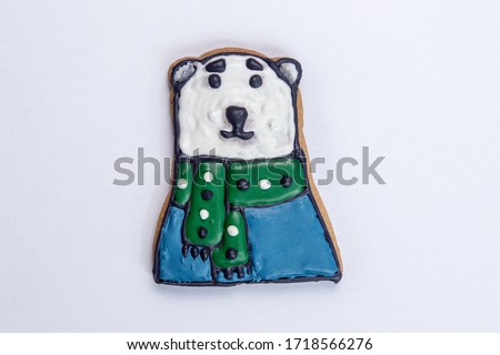 gingerbread for christmas or new year polar bear with a green scarf and blue sweater