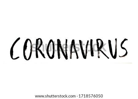 Handwritten text saying 'Coronavirus' in black ink on a white background. Studio shot images of artistic lettering/calligraphy of a word regarding the Coronavirus pandemic