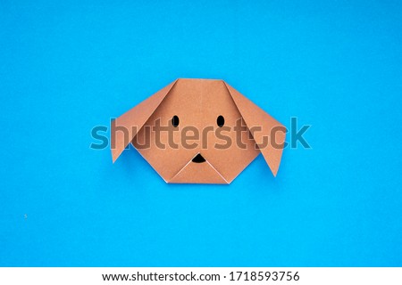 Step by step photo instruction how to make origami paper dog. Simple diy kids children's concept.