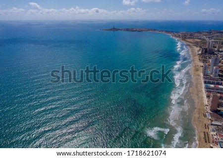 Aerial drone photo of The Sandbar of the Minor Sea, "La Manga" in Spain which is a tiny strip in the middle of the sea with resorts and a beautiful skyline