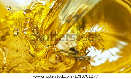 Freeze Motion Shot of Splashing White Wine on Golden Background
