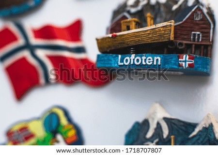 View of traditional tourist souvenirs and gifts from Lofoten Islands, Nordland, Norway, fridge magnets with text "Norway" and key ring key chain, in local vendor souvenir shop
