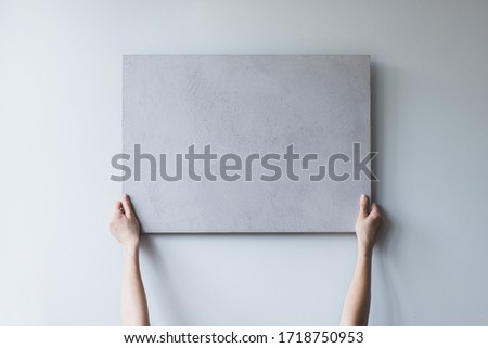 white square picture with two hands on white background