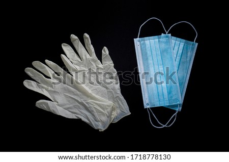 Gloves and masks for protection against viruses on black background