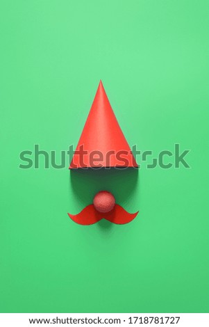 Red cap for birthday, party, Christmas, happy new year and other holiday. On a green background. The minimalist concept. Copy space for your text