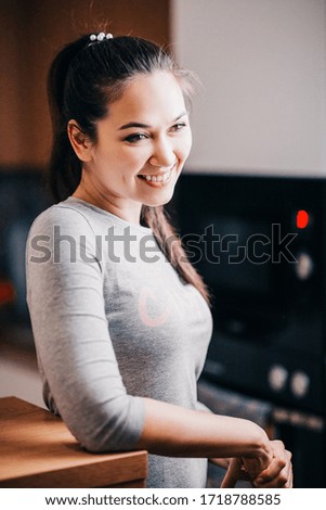 Cheerful smiling brunette in a relaxed home atmosphere - young people communicate in a friendly atmosphere - vintage tinting film grain