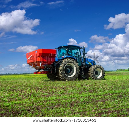 Two-disc fertiliser spreaders with mechanical drive nourishing winter crops, a disk spreader of winter crops with a universal drive shaft Royalty-Free Stock Photo #1718813461