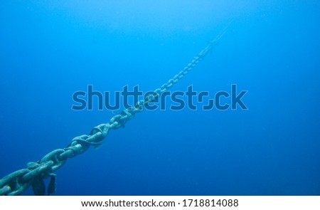 Ship Chained To Anchor In The Caribbean Sea. Blue Water.