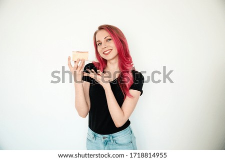 Happy young pretty girl holding a cake on a white background. The concept of eating healthy. 