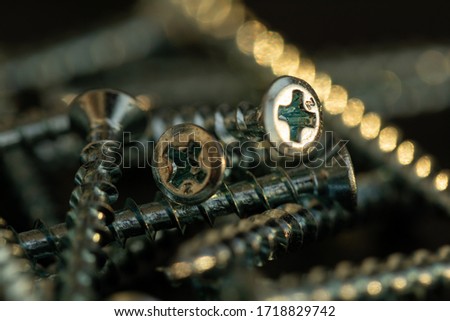 Macro photo of screws. Set of screws. Construction abstraction. Industrial background. Screws macro photo, screw background, steel screw, screw macro. Shiny screws