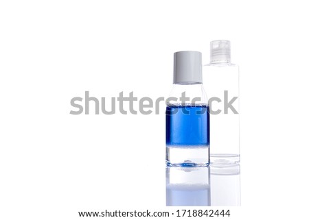 Different cosmetic bottles isolated on white background with copyspace, bottle with blue liquid