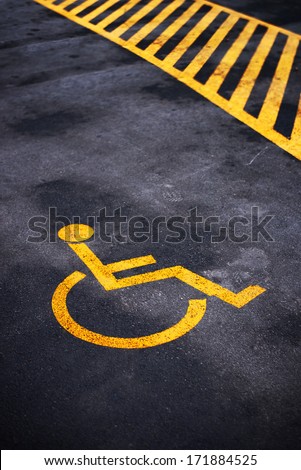 Disabled person parking place permit mark, traffic symbol on the asphalt road