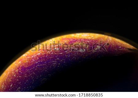 a soap bubble like a planet on a black background