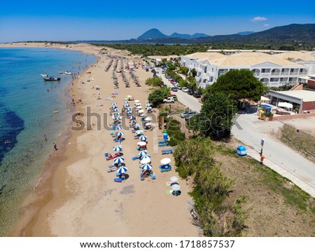 Aerial photo taken in the beautiful coastal area and beach of St George South in Corfu in Greece, taken with a drone on a beautiful sunny day on the Issos beach with sunbathing and relaxing