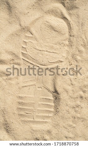 footprint in the sand , close up