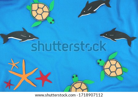 Marine biodiversity conservation and World Environment Day concept. Sea animals cutout in blue sea background. Top view, flat lay with copy space.