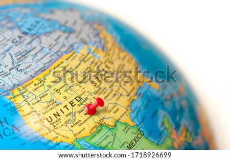 USA map. Earth globe close up with a red pin in United States.