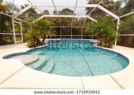 Enclosed backyard pool in South Florida Royalty-Free Stock Photo #1718950042