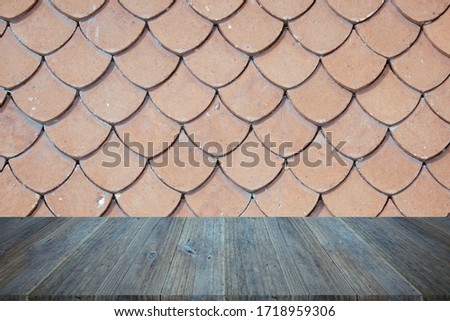 Tile roof of old Thai temple texture abstract texture surface background use for background with wood table or terrace