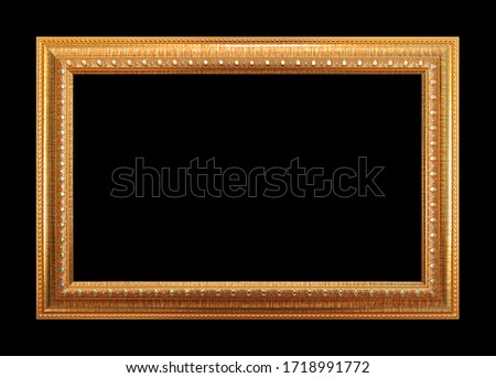 Rectangular empty wooden and gold gilded frame isolated on black background
