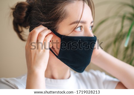 COVID-19 Pandemic Coronavirus A young woman wearing black face mask, Dust protection against virus. Coronavirus Royalty-Free Stock Photo #1719028213