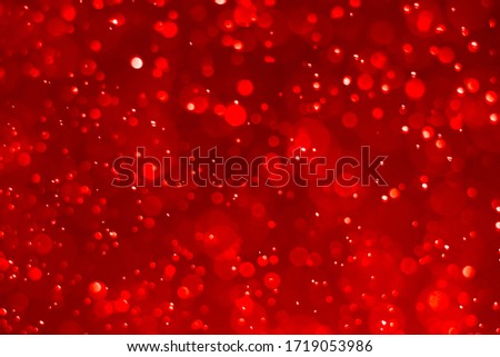 Red and green glitter vintage lights background. Red bokeh shiny on dark
 background.