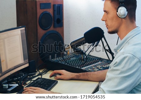 Handsome happy radio host moderating in studio