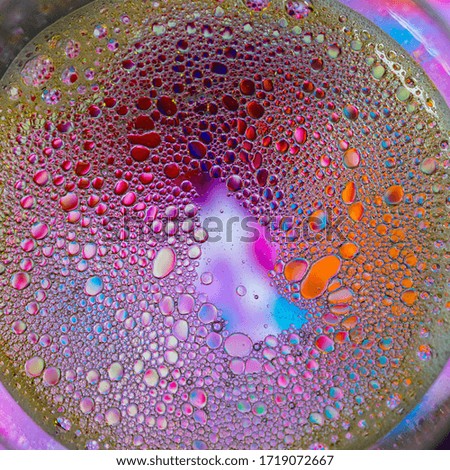 water and oil on a multicolored background