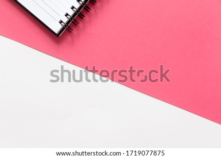 Cut out notepad on split color pink and white background. with copy space. 