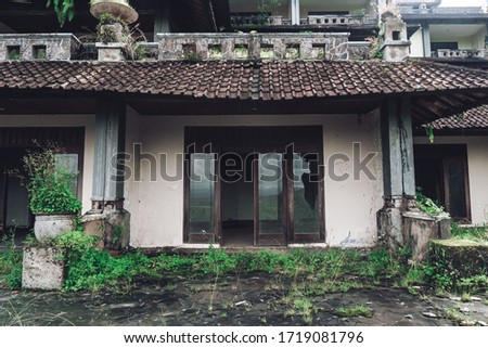 Dark photo of abandoned building with dirty walls and broken roof