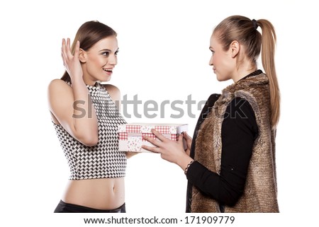 happy girl gets a gift from her girl friend