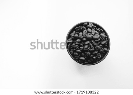 Brown coffee beans closeup on  white background. Flat lay, top view. Copy space for text.