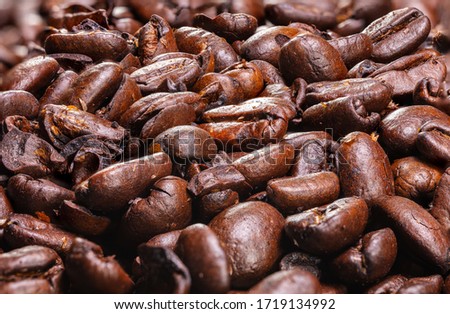 Close up to a heap of coffee beans.
Macro photography of fresh roasted coffee beans high resolution. Detailed macro picture on roasted coffee beans.  Close-up of brown coffee beans background  image