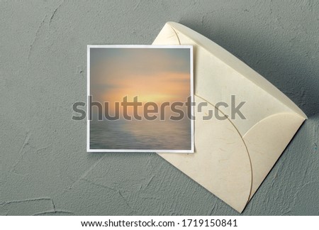 Envelope with a marine postcard on the table - top view