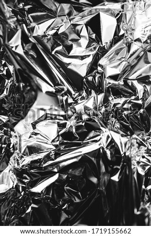 crumpled silver foil sheet,texture of shiny crumpled piece foil