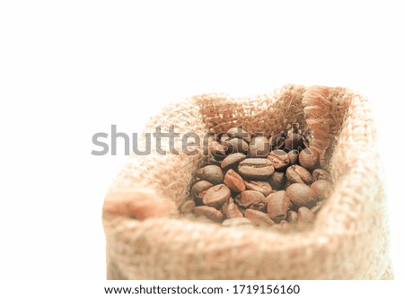Coffee beans in a sack bag on white background