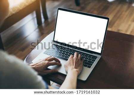 computer mockup image blank screen with white background for advertising,hand woman work using laptop contact business search information on desk at coffee shop.marketing and creative design