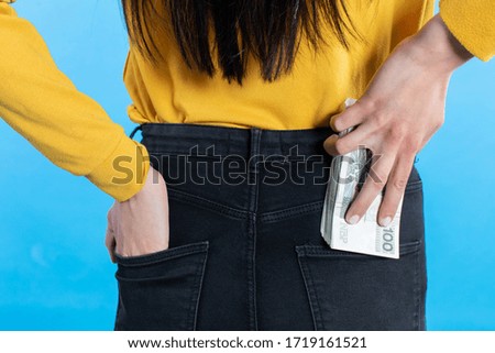 A cash file in the back pocket is a sign of financial wealth.