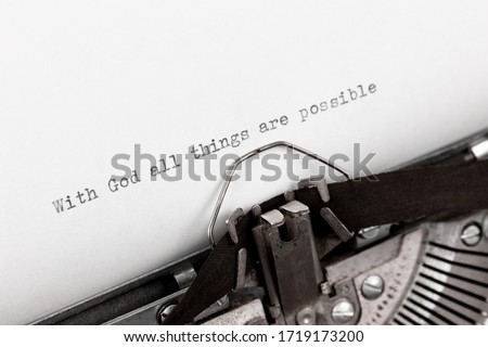 Typing a holy bible quote with God all things are possible on a vintage typewriter Royalty-Free Stock Photo #1719173200