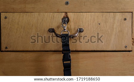 key in lock of wooden desk drawer, closeup Royalty-Free Stock Photo #1719188650