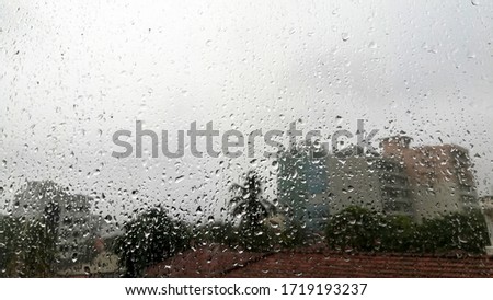 Rainy day rainy time rainy water drops diffuse on the glass with outdoor dark background