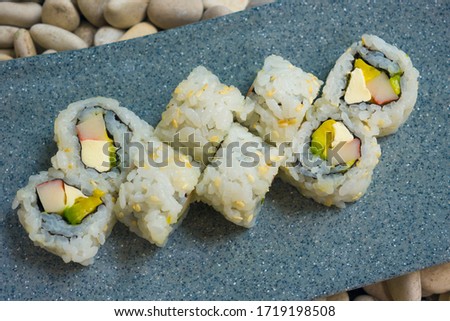 Japan gourmet cuisine - closeup and detail on delicious and delicate dish of Japanese sushi rolls in slate on stone background in traditional healthy Asian food and creative oriental dining concept