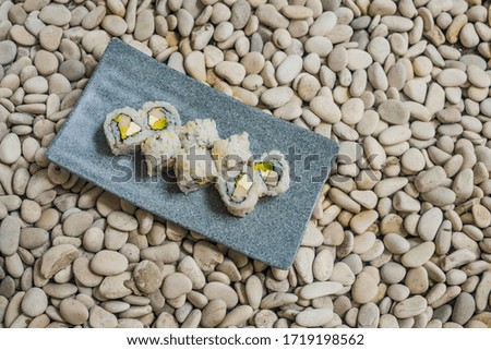 Japan gourmet cuisine -  delicious and delicate dish of Japanese sushi rolls in slate on stone background in traditional healthy Asian food and creative oriental dining concept
