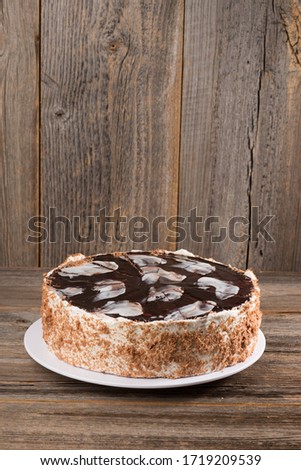 Vanilla cream whole milk cake from a pastry shop on a wooden surface