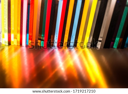light through Stack of different colours Cast Acrylic Sheet on black background