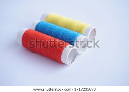 thread with basic colors (red, blue and yellow) on white background