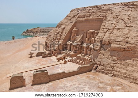 Aerial view over exterior entrance to ancient egyptian temple of Ramses II in Abu Simbel with giant statues to Lake Nasser Royalty-Free Stock Photo #1719274903