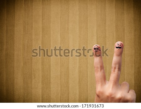 Happy finger smileys faces on hand with vintage stripe wallpaper background
