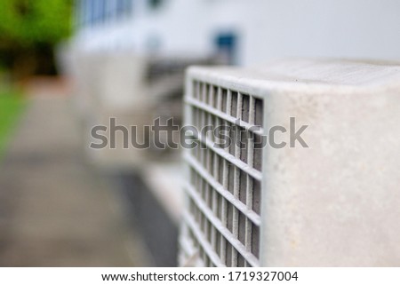 A sequence of air conditioners outside an inn